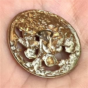 A 19th c. brass button of two children.