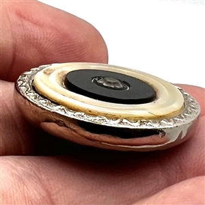 Sporting target button with four materials.