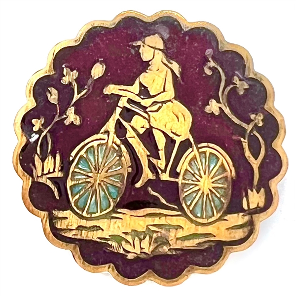 Enamel button of a girl riding a bicycle. 