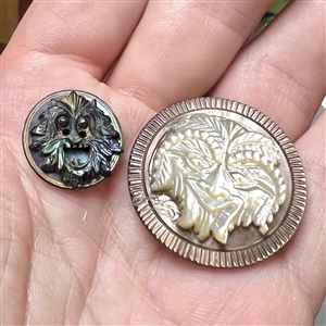 Two Greenman buttons of carved united pearl. 