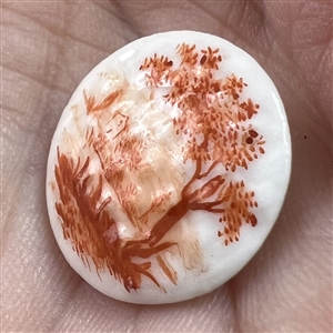 A 19th c. Mennecy porcelain button  of a river scene.