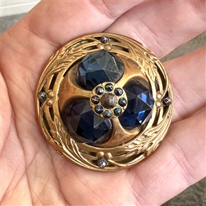 Gorgeous and unique true Gay 90's button with three faceted blue glass jewels and blued steels.