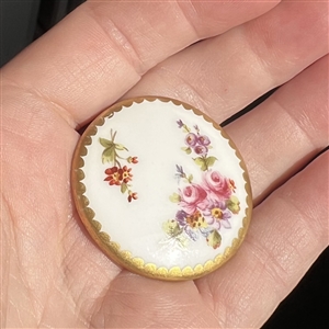 A 19th c. Porcelain button of flowers with Sevres back mark.