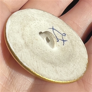 A 19th c. Porcelain button of flowers with Sevres back mark.