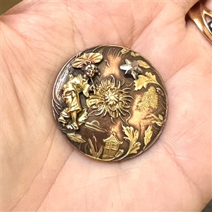 Highly unusual metal worked button of an Asian woman and Asian elements with riveted cut-steel star. 