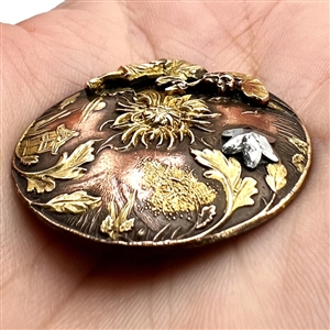 Highly unusual metal worked button of an Asian woman and Asian elements with riveted cut-steel star. 