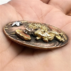 Highly unusual metal worked button of an Asian woman and Asian elements with riveted cut-steel star. 