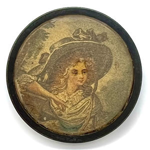 Printed fabric under glass button of a woman in a huge hat.