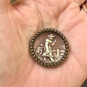 “Victorian Girl Ivoroid button mounted in brass.