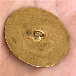 A 19th c. enamel button of woman with a fan.