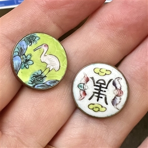 Two enamel buttons of birds.