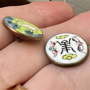 Two enamel buttons of birds.