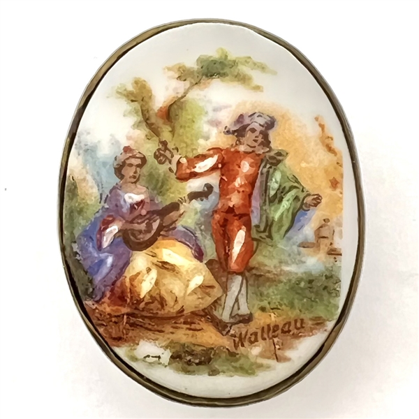 Porcelain oval button of a man and woman done in “Watteau" style.