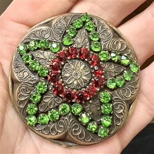 Huge brass jewel button of a star with green and red pastes.