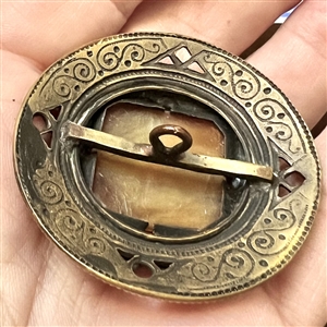 Gay 90's button with glass jewel center.