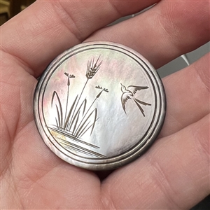 Engraved smoky pearl button of water plants and flying swallow.