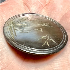 Engraved smoky pearl button of water plants and flying swallow.