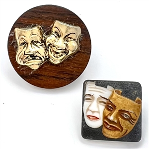 Two buttons of theatre masks.