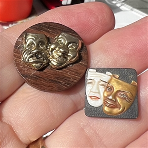 Two buttons of theatre masks.
