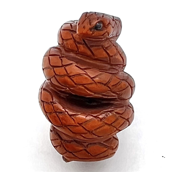 Carved boxwood coiled snake button.