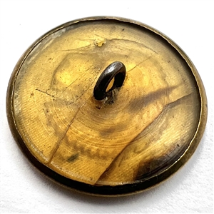 Five sporting buttons of various materials.