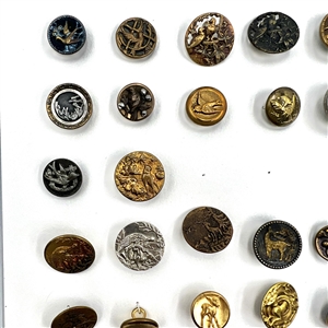 Two cards of 99 metal picture buttons. 
