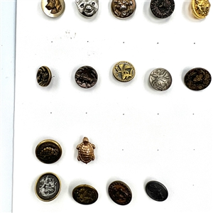 Two cards of 99 metal picture buttons. 