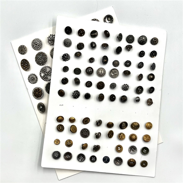 Two cards of 102 steel, brass and other metal buttons. 