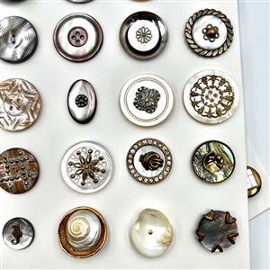 Two cards of 63 pearl and shell buttons. 